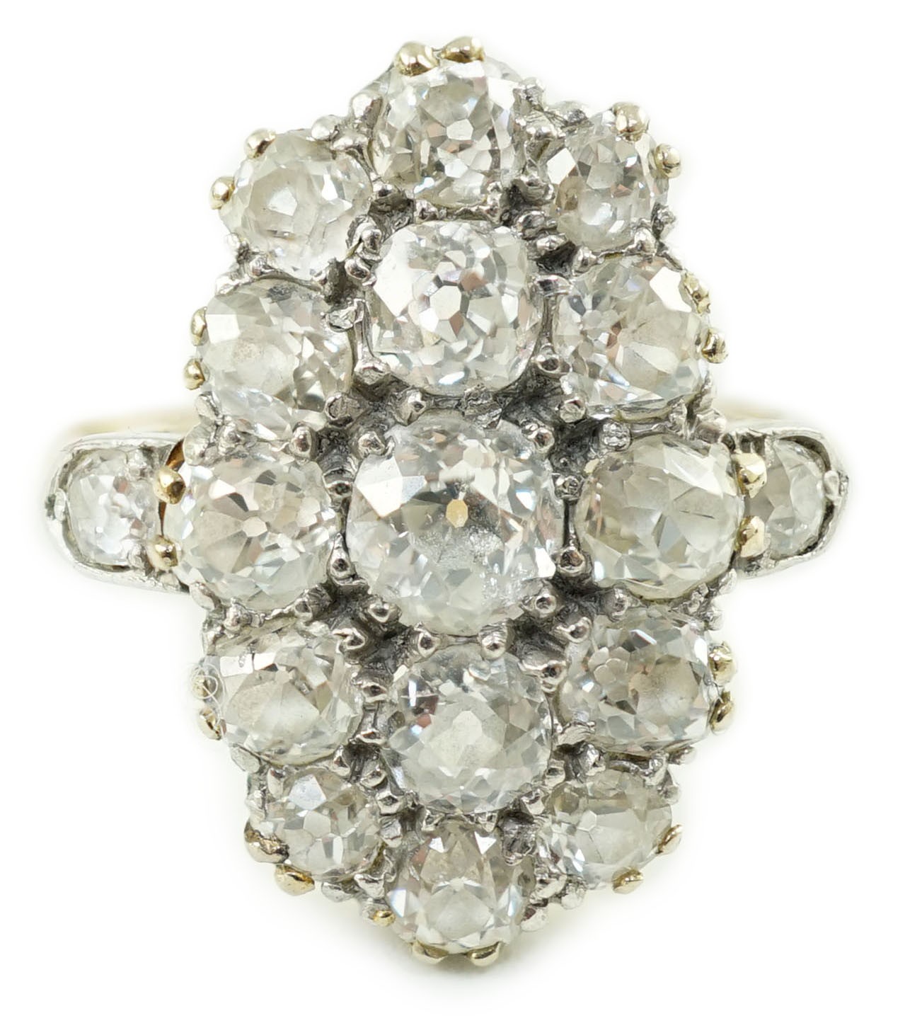 An 18ct gold and oval diamond cluster dress ring, with diamond set shoulders